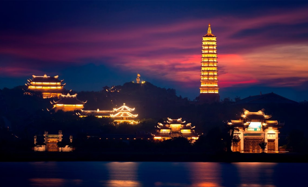 By night, Bai Dinh Pagoda shimmers in golden light